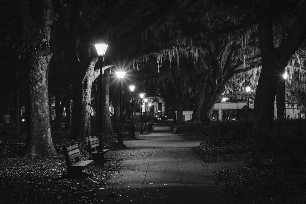 A path in Forsyth Park, dimly lit by gas lanterns. The park is considered one of the most haunted places in Savannah Georgia