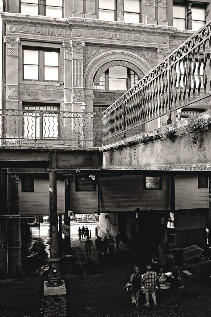 Savannah Cotton Exchange Building with people walking on the Drayton Street Ramp beneath