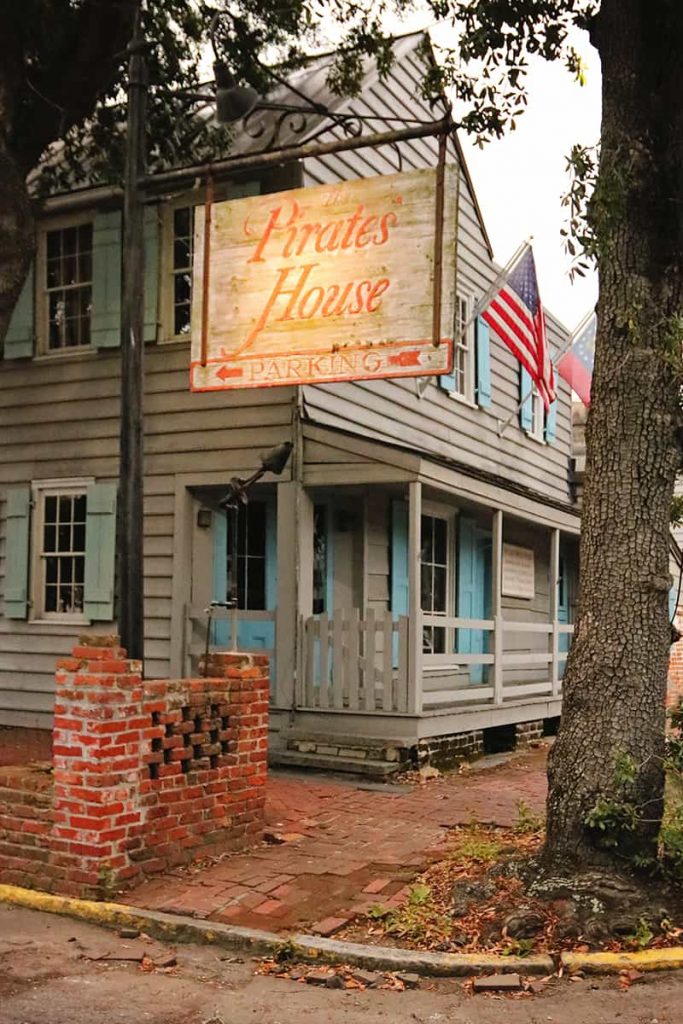 Gray wooden structure with turquoise shutters