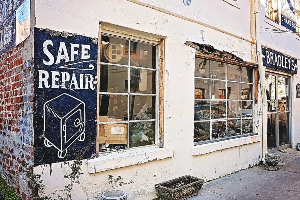 Crumbling old building with painted on signs or safe repairs plus lock and key work