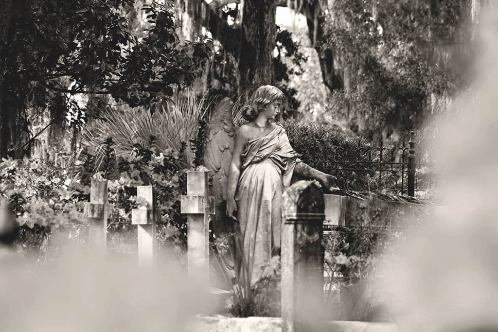 Statue of an angel surrounded by headstones