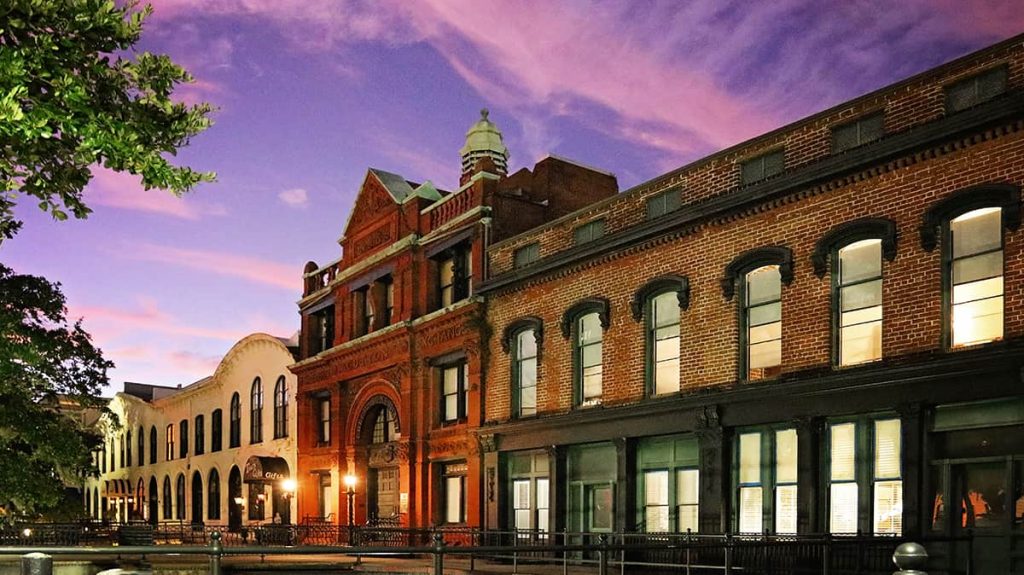 Pink and purple sunset over the Cotton Exchange building and other warehouses on Factors Walk