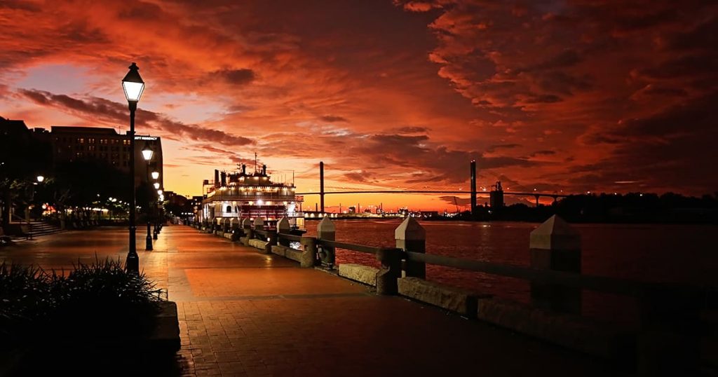 River Street Savannah GA with a fiery red and orange stormy sky in the background