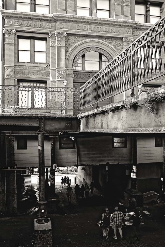 Old Cotton Exchange Building with a ramp and people walking beneath