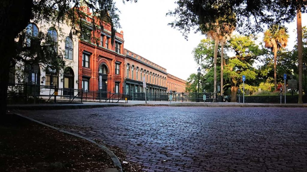 Looking towards a brick street towards warehouses in the distance