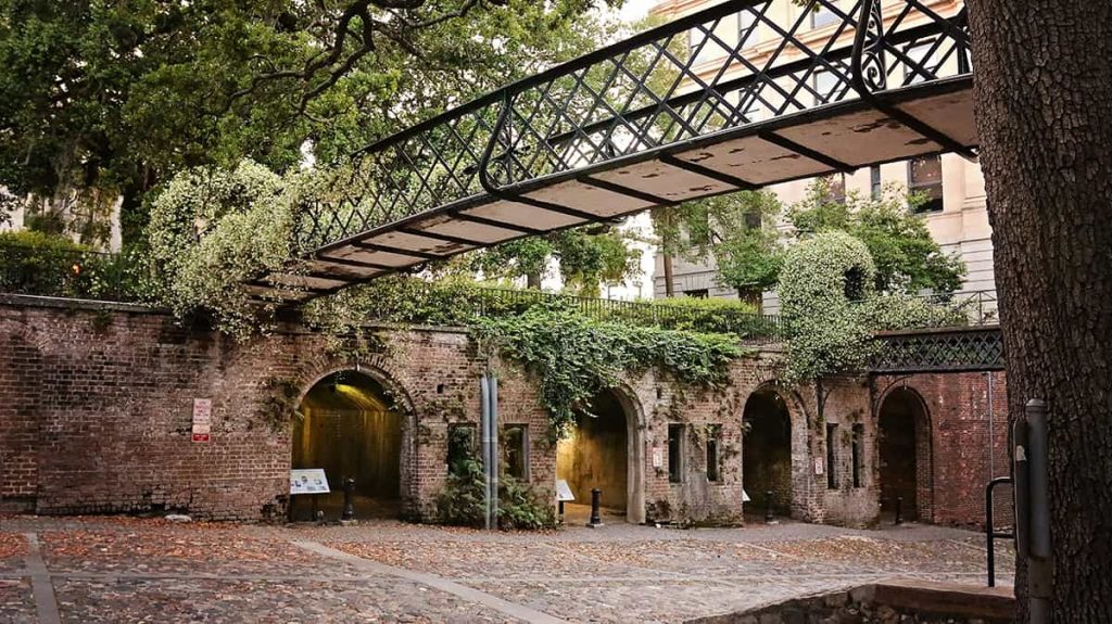 The Cluskey Vaults on the lower level of Factors Walk with a walking bridge covered in jasmine stretching overhead