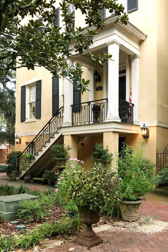 Upper level front entry to a yellow stucco home on Historic Jones Street in Savannah GA