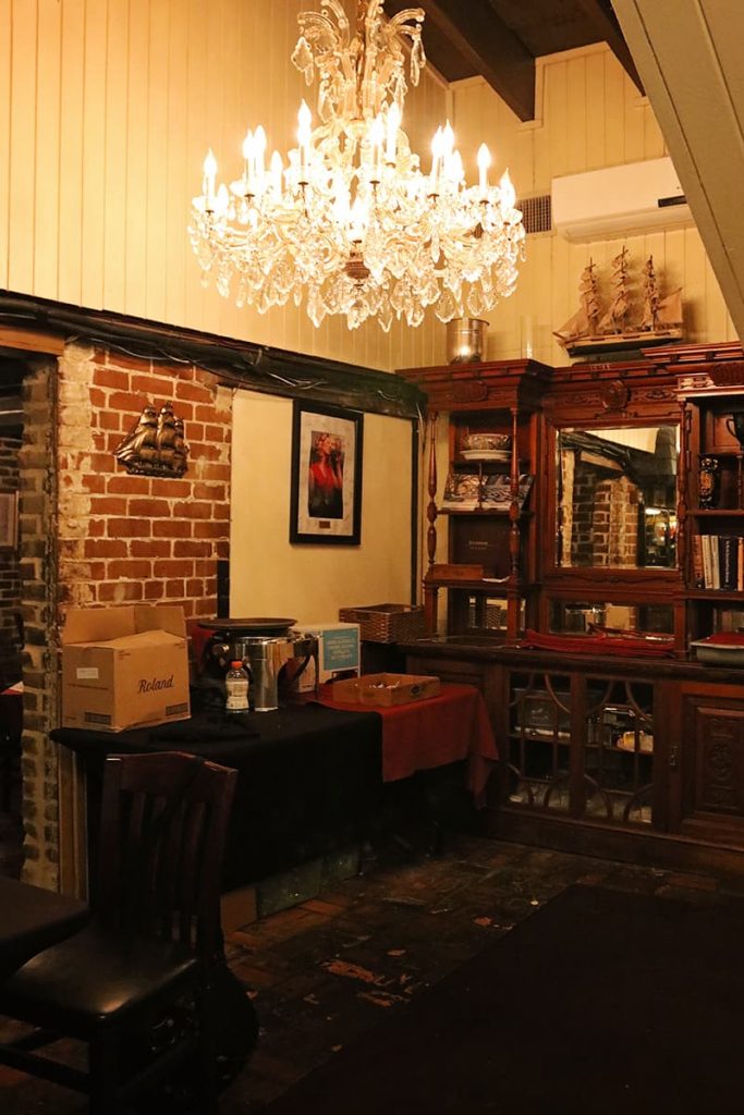 Office space with an antique desk and chandelier at the haunted 7Hundred90 Inn in Savannah