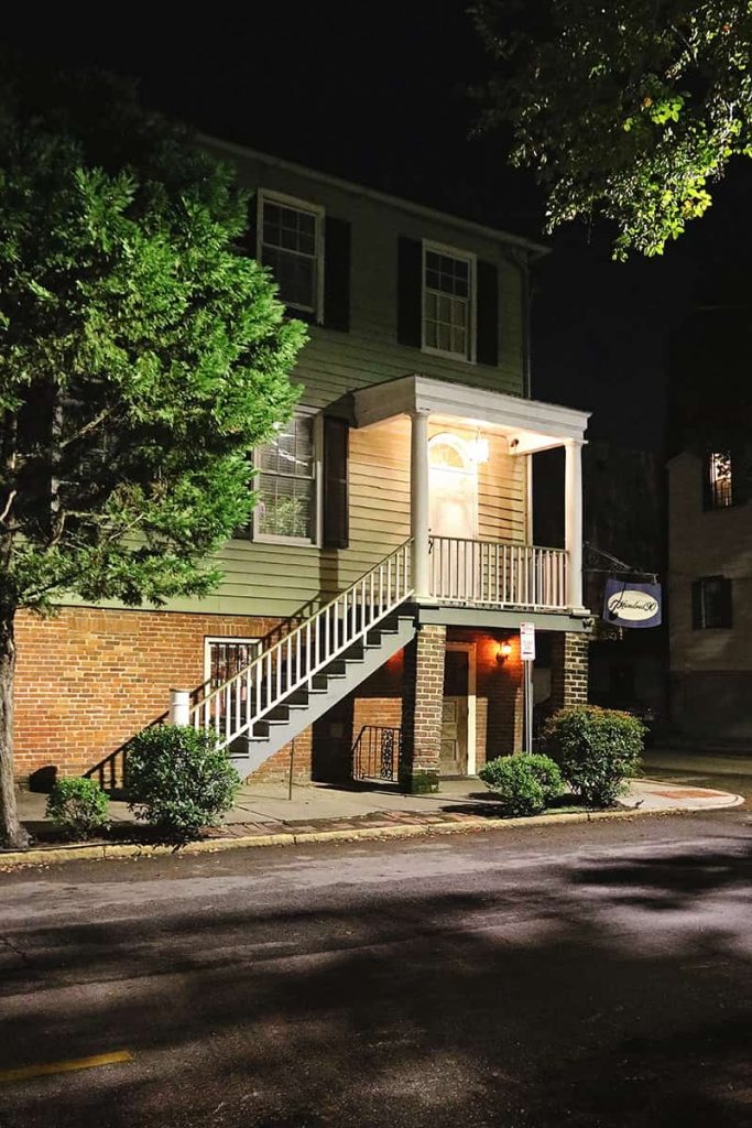Three-story inn lit up at night with spooky lighting
