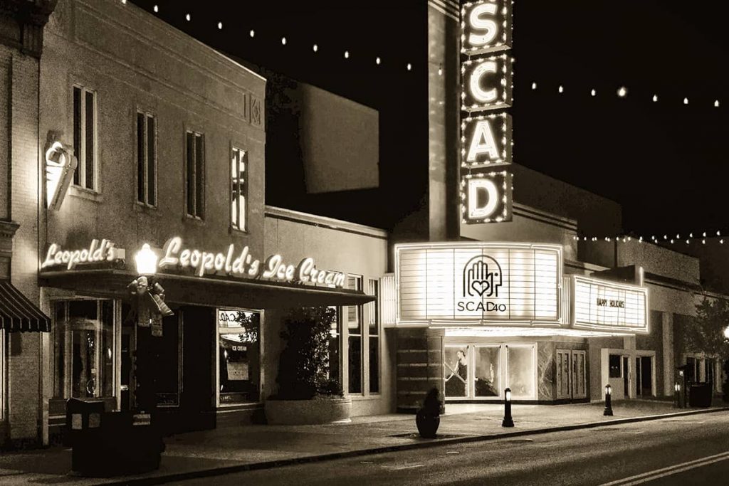 Broughton Street in Savannah at night without a soul in sight and only the neon glow of the SCAD and Leopold's Ice Cream signs lighting the street