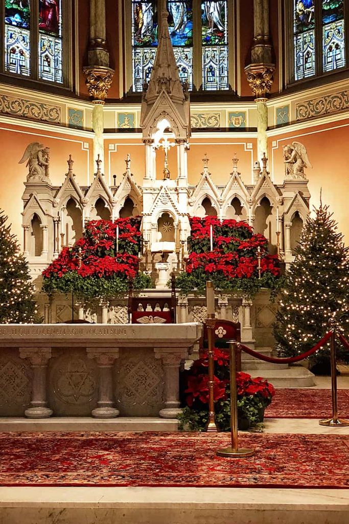 Interior of the Cathedral Basilica of St. John the Baptist withChristmas trees and poinsettias