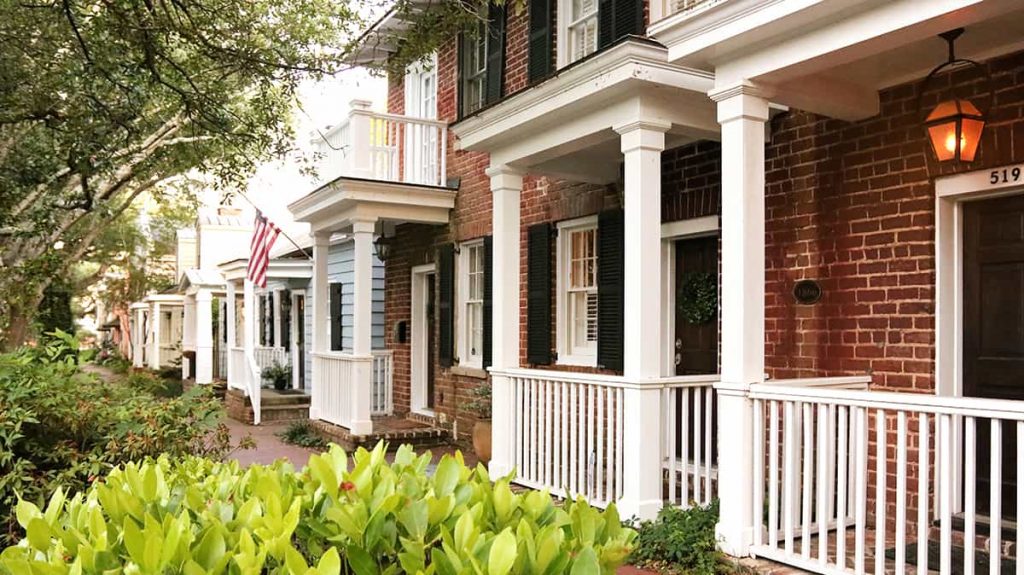 Homes with small porches and pretty landscaping on the far east end of Jones Street in Savannah GA