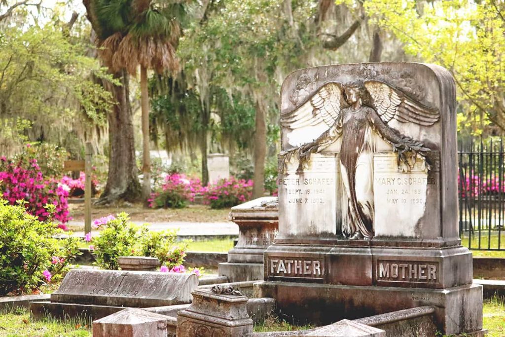 Dual mother/father headstone with an angel guarding both sides