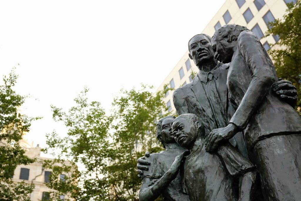 Close up of steadfast faces of the family carved into the African American Monument in Savannah