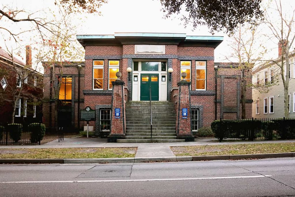 Exterior view of the Carnegie "Colored" Library in Savannah. 2-story red brick building with steep steps leading to a green door