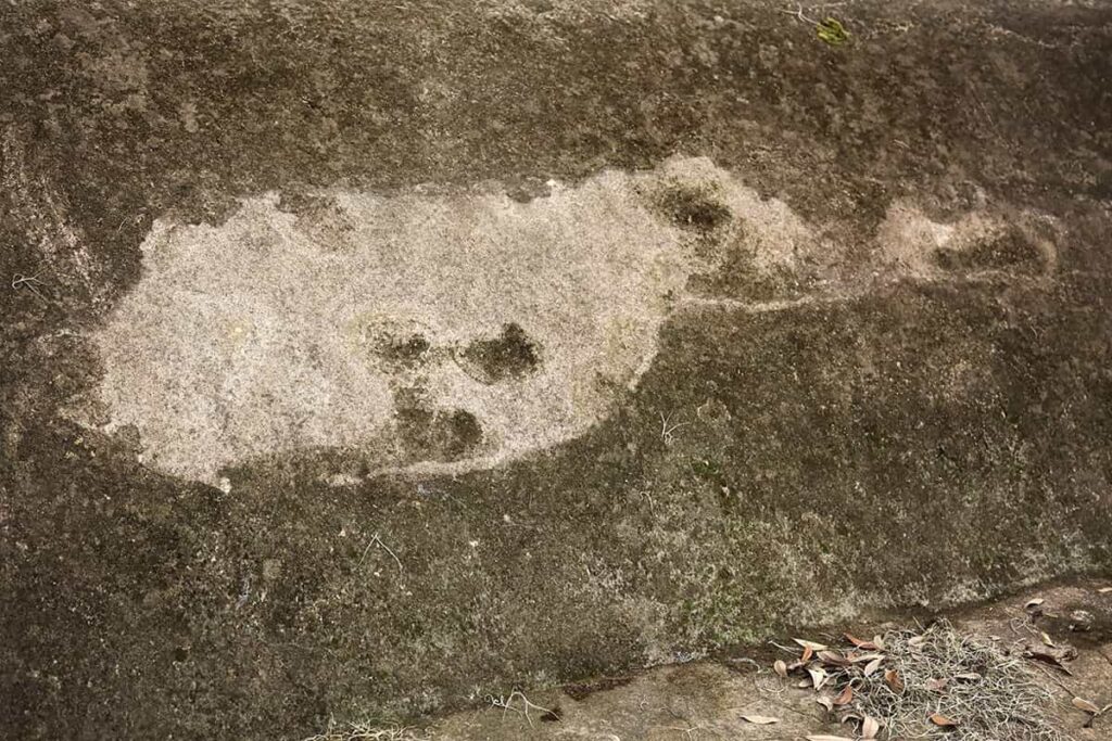Close-up of a white spot on an old vault in Colonial Park Cemetery that resembles the shape of a ghost