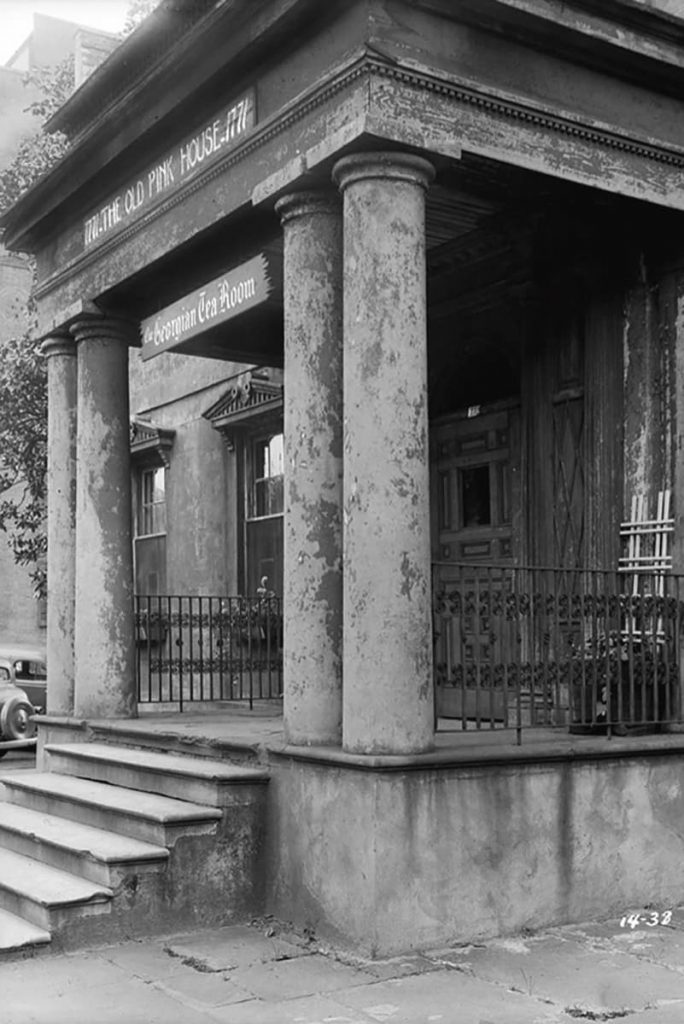 B&W photo of the run-down portico of The Olde Pink House when it was operating as the Georgian Tea Room. Old-timey cars can be seen in the background