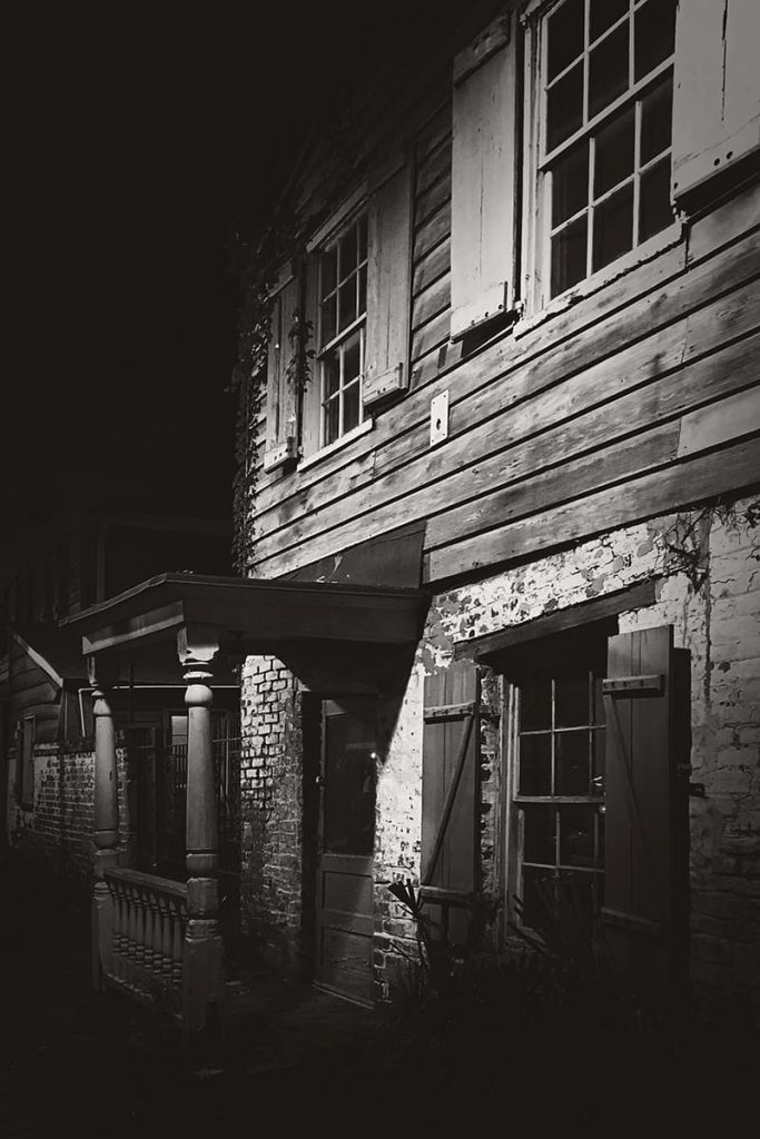 Spooky B&W night image of the Pirates' House, one of the most haunted restaurants in Savannah