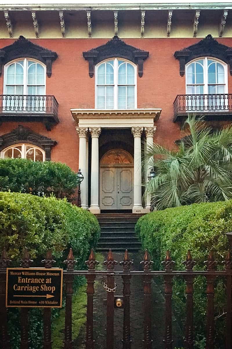 The very recognizable Italianate-style brick and wrought iron front facade of the Mercer Williams House