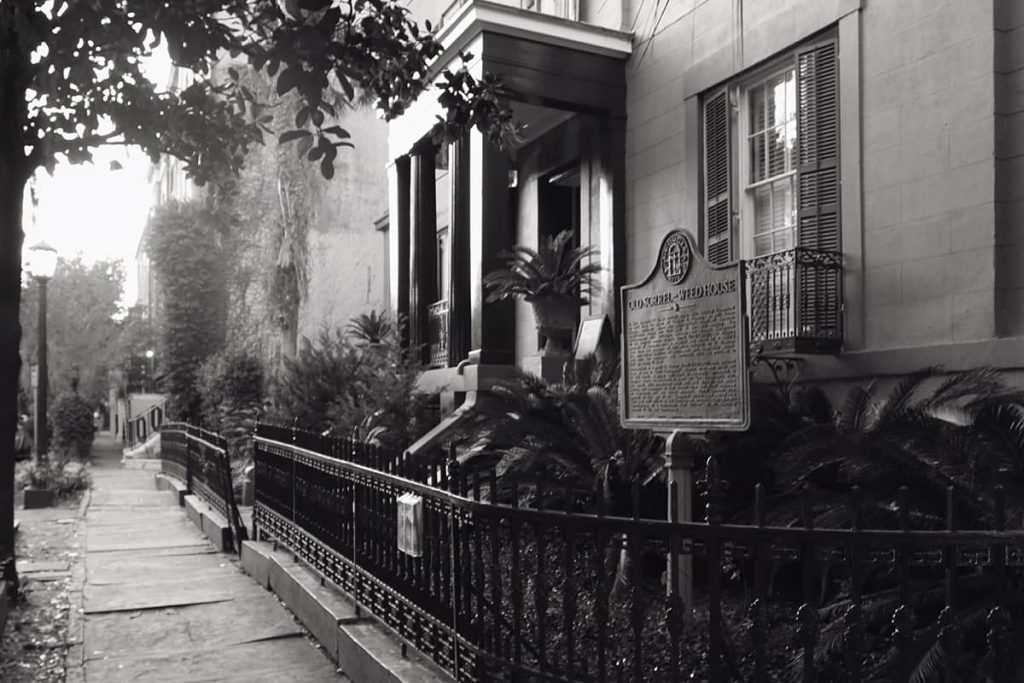 B&W image of the exterior front entrance of the haunted Sorrel-Weed House in Savannah