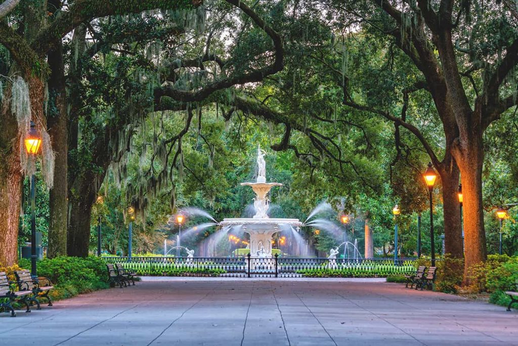 The Savannah Georgia must-see fountain in Forsyth Park is surrounded by oaks covered in Spanish moss