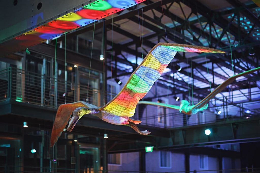 Large metal pterodactyl statues hanging from the ceiling of the JW Marriott Plant Riverside