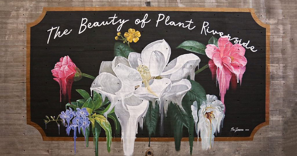 Mural of colorful flowers on a black background with text that reads The Beauty of Plant Riverside