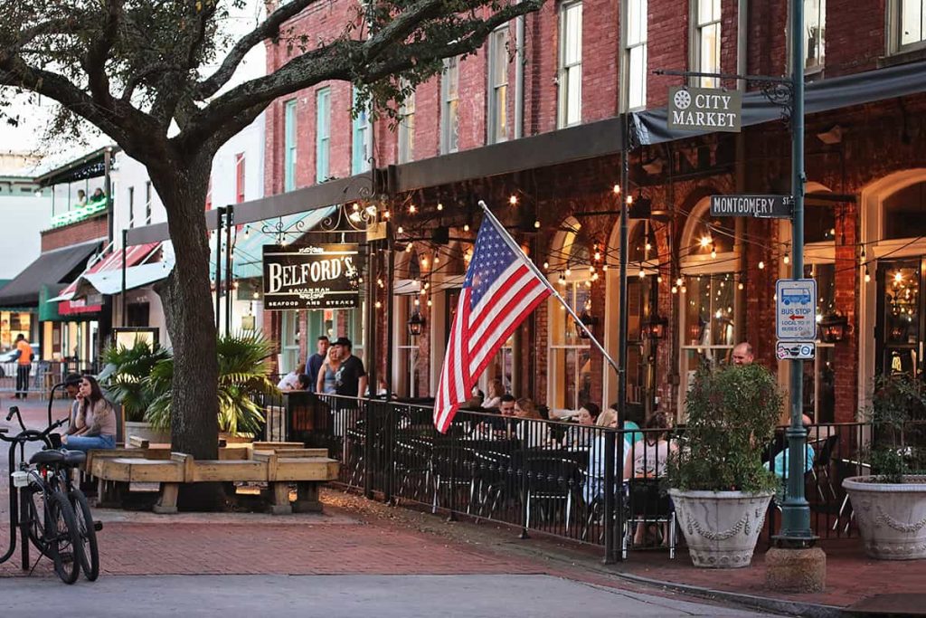 Covered patio at Belford's restaurant in Savannah's City Market with twinkle lights and fans over rows of outdoor seating