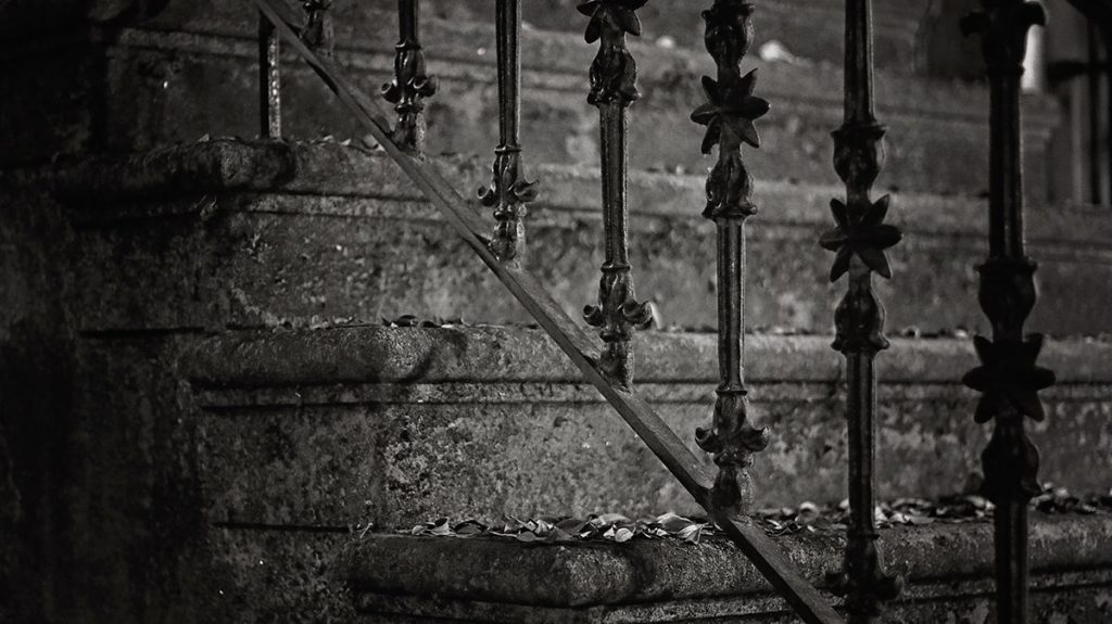 BW image of spooky stairs with wrought iron railings