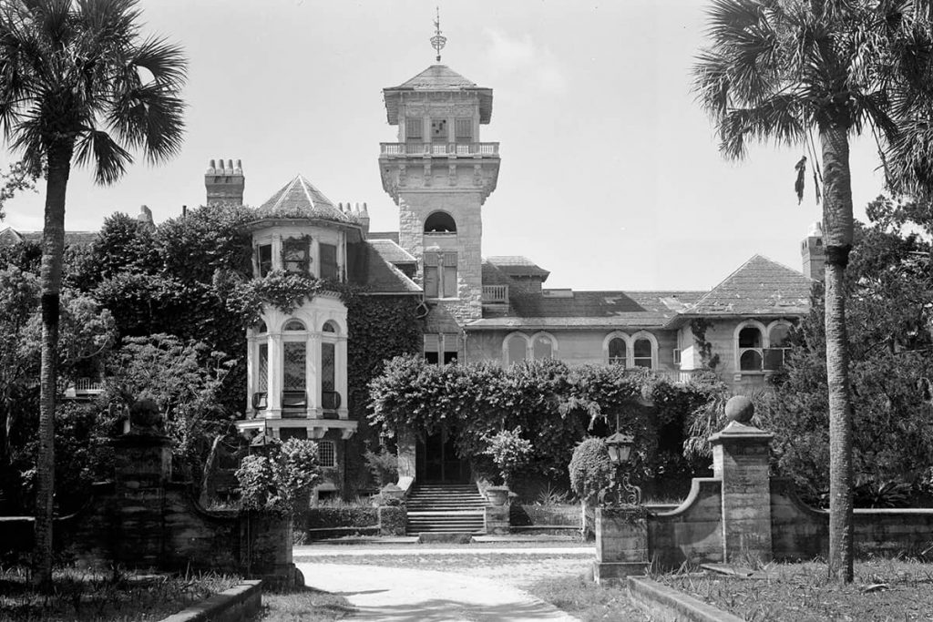 B&W image of the driveway leading to the stately Dungeness Mansion, with a turret featured prominently in the home's design