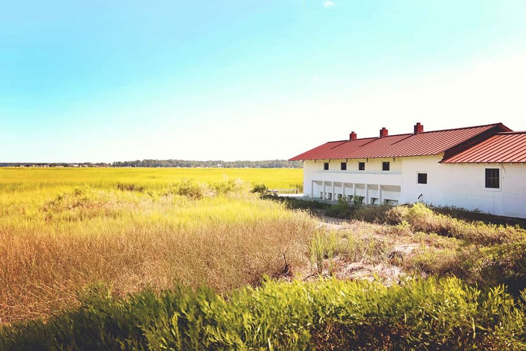 Wide angle view of a marsh scene with the A.S. Varn and Son Oyster Factory building in sight