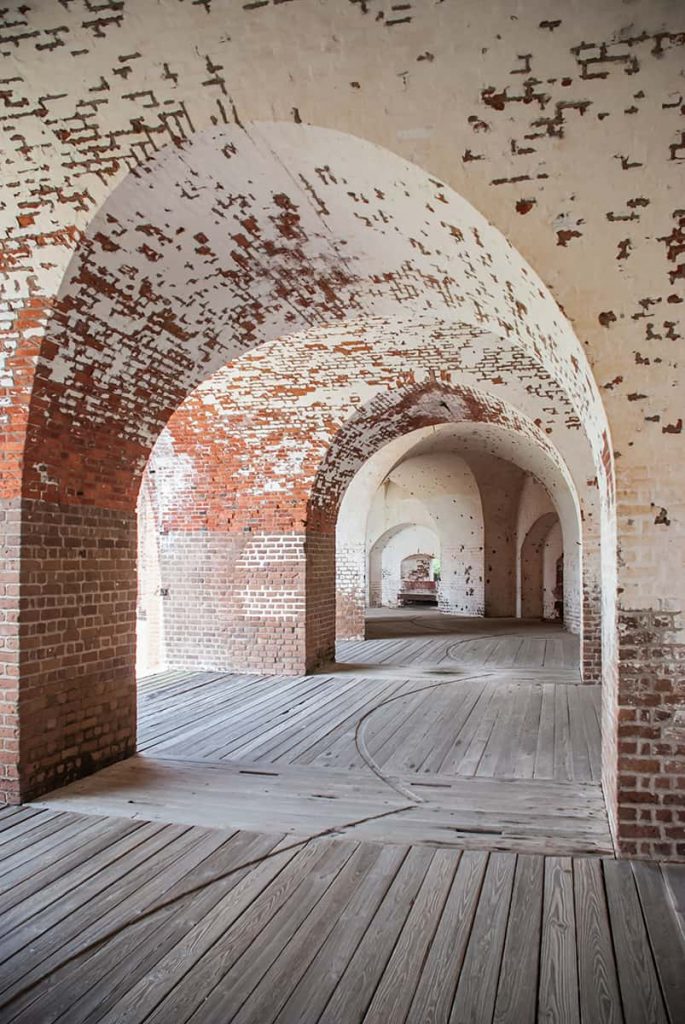Curved brick walls with remnants of white paint inside Fort Pulaski National Monument near Tybee Island on the Georgia Coast