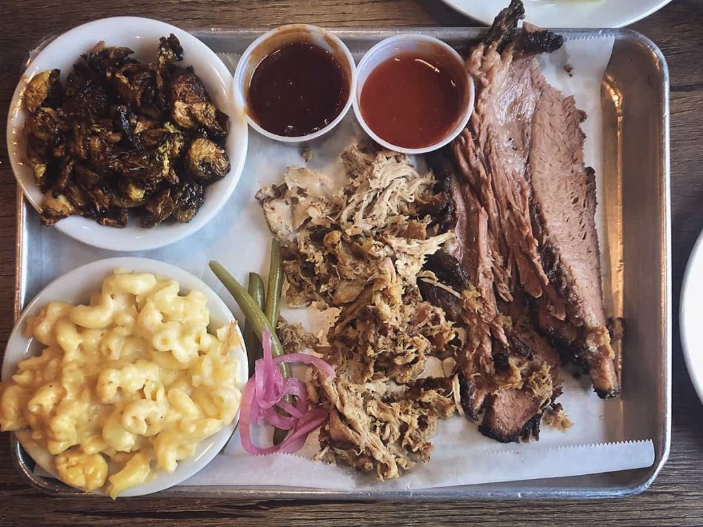 A BBQ tray loaded with mac 'n cheese, brussels sprouts, pulled pork, and sliced brisket at Erica Davis Lowcountry in Savannah