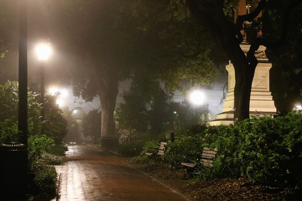 A dense fog settles over Wright Square in the dark early-morning hours in Savannah, providing a sinister aura