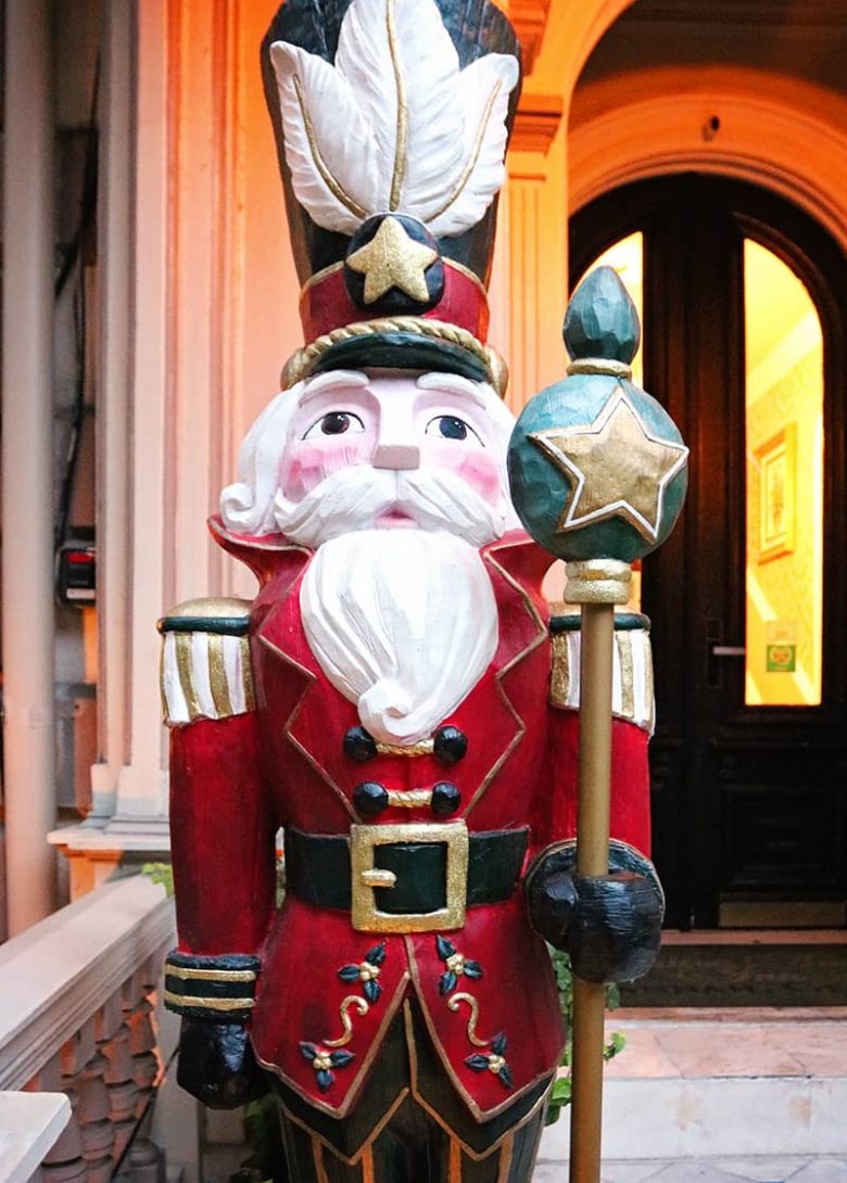 A life-sized nutcracker wearing a red and green suit stands in front of the Hamilton-Turner Inn -- one of the B&Bs in Savannah that decorate for Christmas.