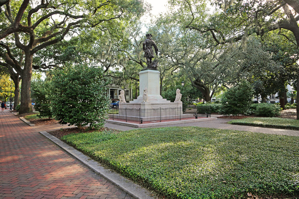 Wide-angle scene of Chippewa Square with a large statue in the center surrounded by brick-paved paths and trees
