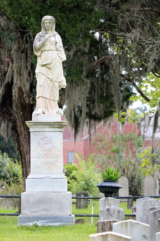 The Silence statue shows a female on a pedestal. Two arms have been broken off of the statue and remnants of red spray paint are visible on the statue
