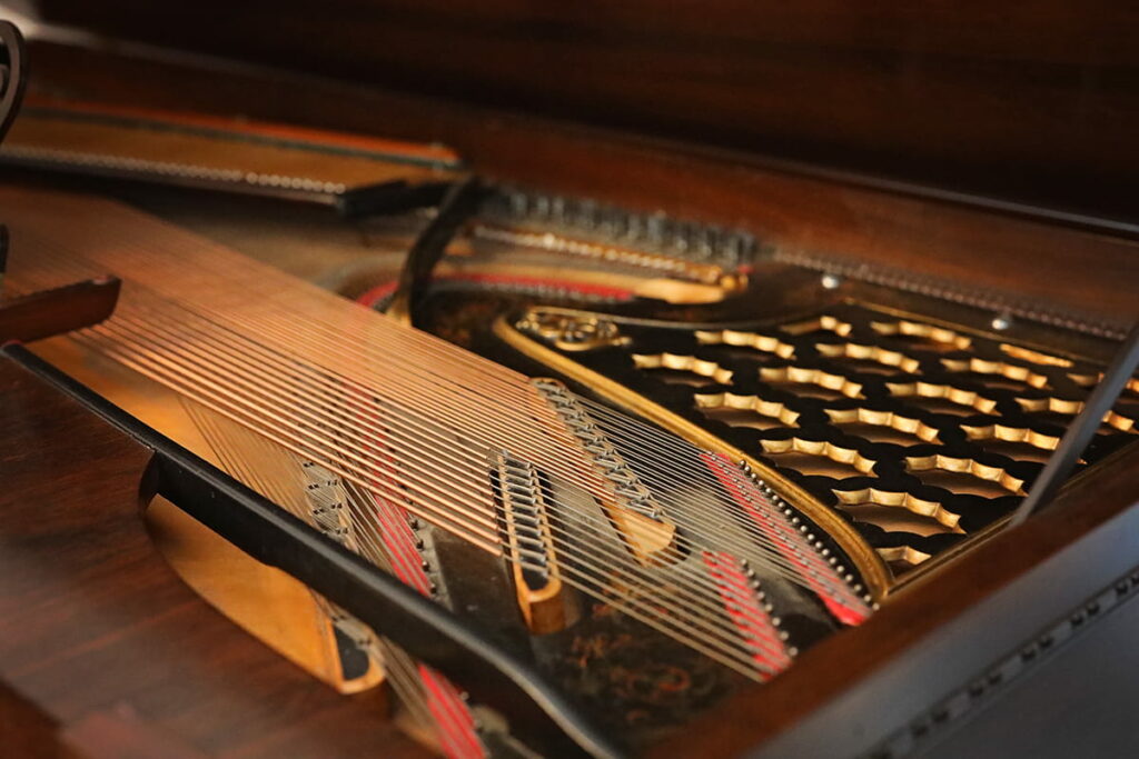 Gold-trimmed details on the interior of a beautiful and rare antique square Steinway piano