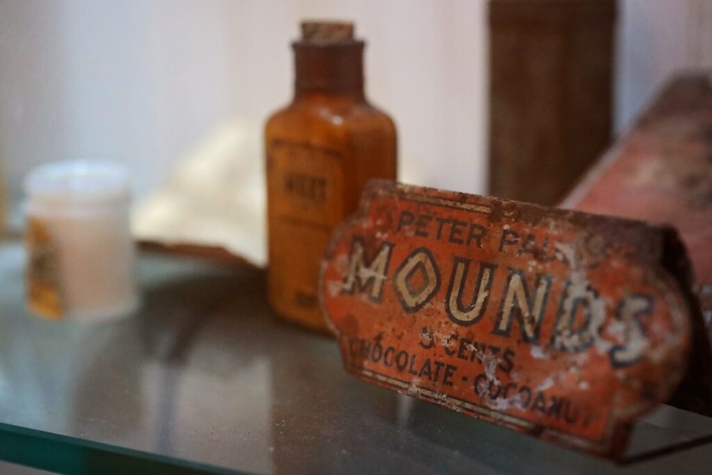 Vintage and rusted metal sign with "Peter Pauls Mounds 5 Cents Chocolate - Cocoanut" on it