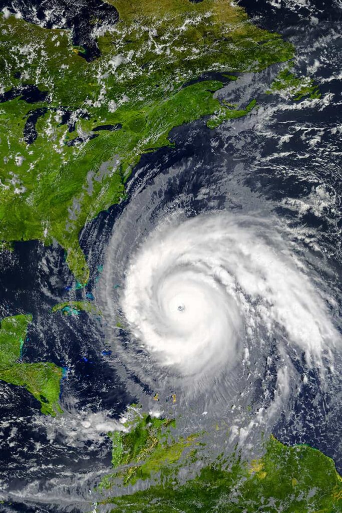 The feature image for an article about travel insurance for hurricanes shows a satellite image of a hurricane headed towards the East Coast of the United States