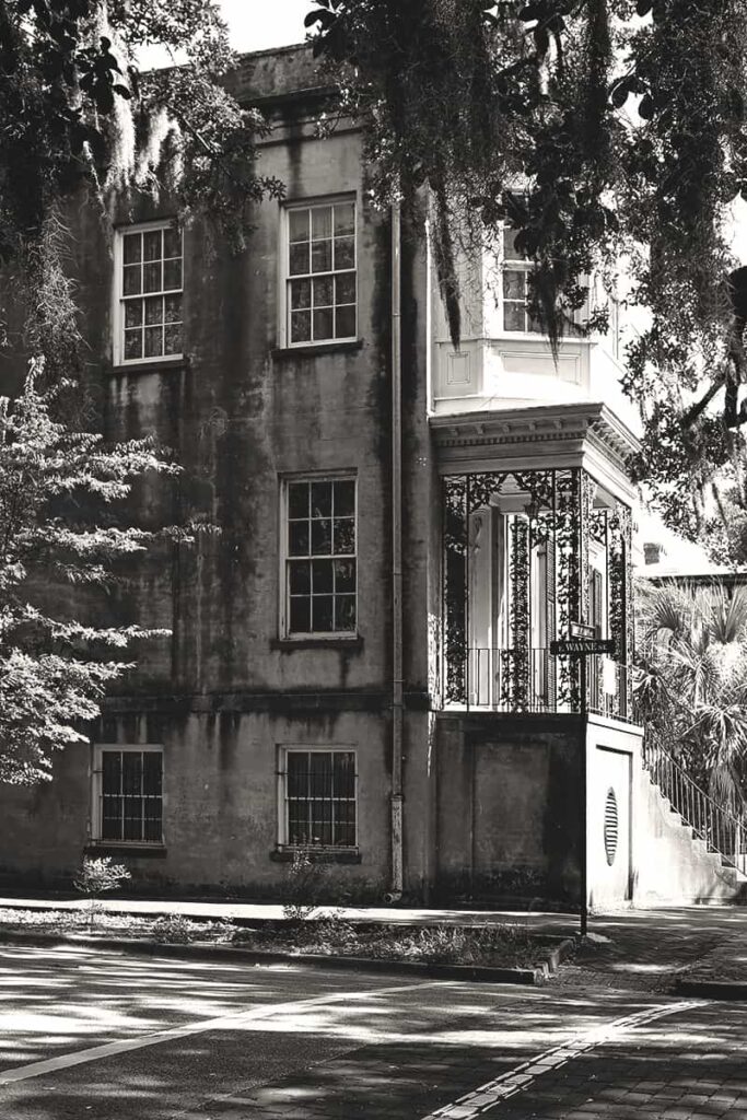 A side view of the three-story home located at 432 Abercorn Street in Savannah before its restoration. It's considered one of the city's most haunted places, and in this photo it appears abandoned and has dark patches of mold covering much of the side wall