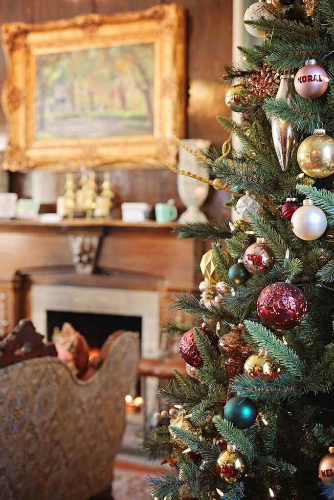 The Eliza Thompson House is one of the bed and breakfasts in Savannah that decorates for Christmas, evidenced by this scene of an elegant tree and cozy seating area next to the fireplace