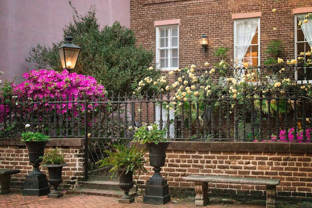 A courtyard on Jones Street in Savannah is bursting with spring color from hot pink azaleas and yellow climbing roses