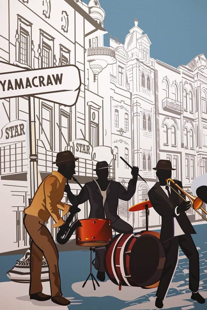 B&W illustration of historic Yamacraw in Savannah with three jazz players playing instrument in color in the foreground