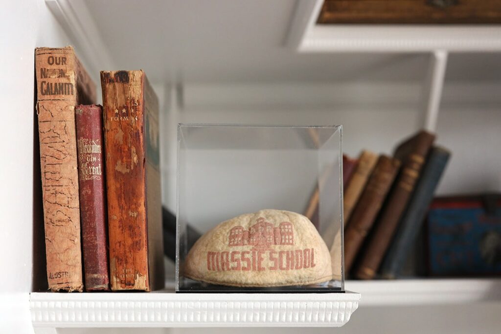 Old school book and a display case with items from Massie School, one of the best history museums in Savannah