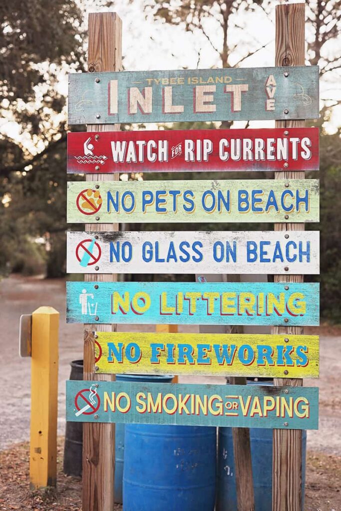Tybee Island Inlet Ave sign showing the many rules of the beach, such as "No Pets on Beach," "No Glass on Beach," "No Littering," "No Fireworks," and "No Smoking or Vaping"