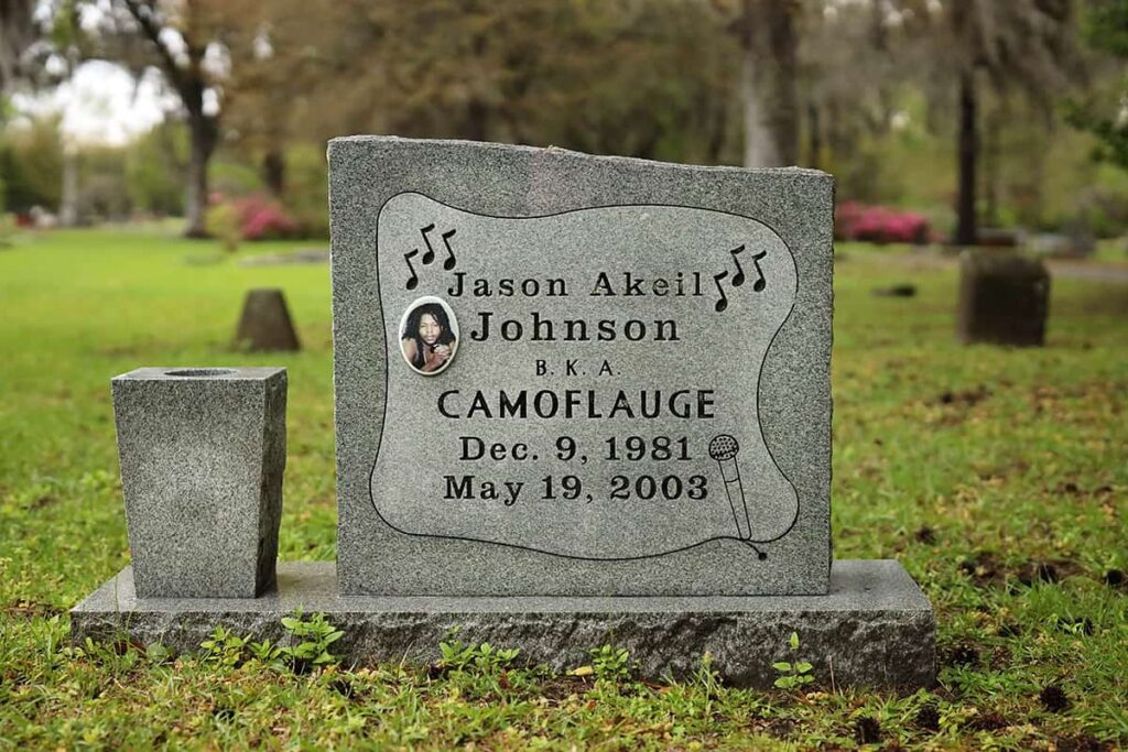 Square-shaped granite headstone in Laurel Grove Cemetery (South) with a granite planter attached. The marker reads, "Jason Akeil Johnson | B.K.A. Camoflauge | Dec. 9, 2981 | May 19, 2003"