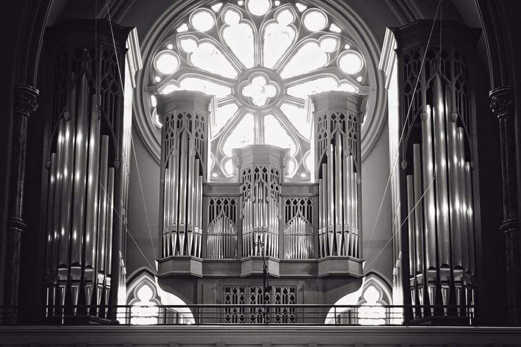 B&W photo of the pipe organ in the choir loft of the Cathedral Basilica of St. John the Baptist