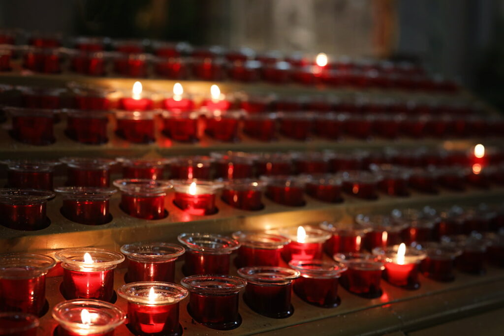 Rows of red votives inside the Savannah cathedral. Ten of them are lit in remembrance of loved ones
