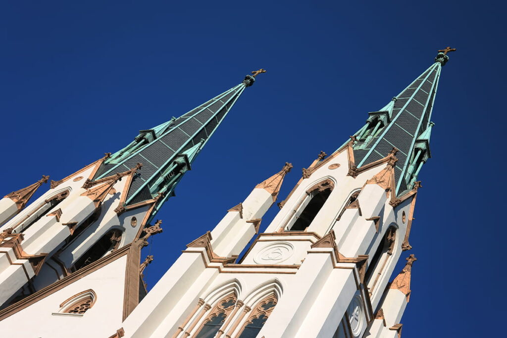 The twin spires of the Cathedral of St. John silhouetted against a dark blue sky